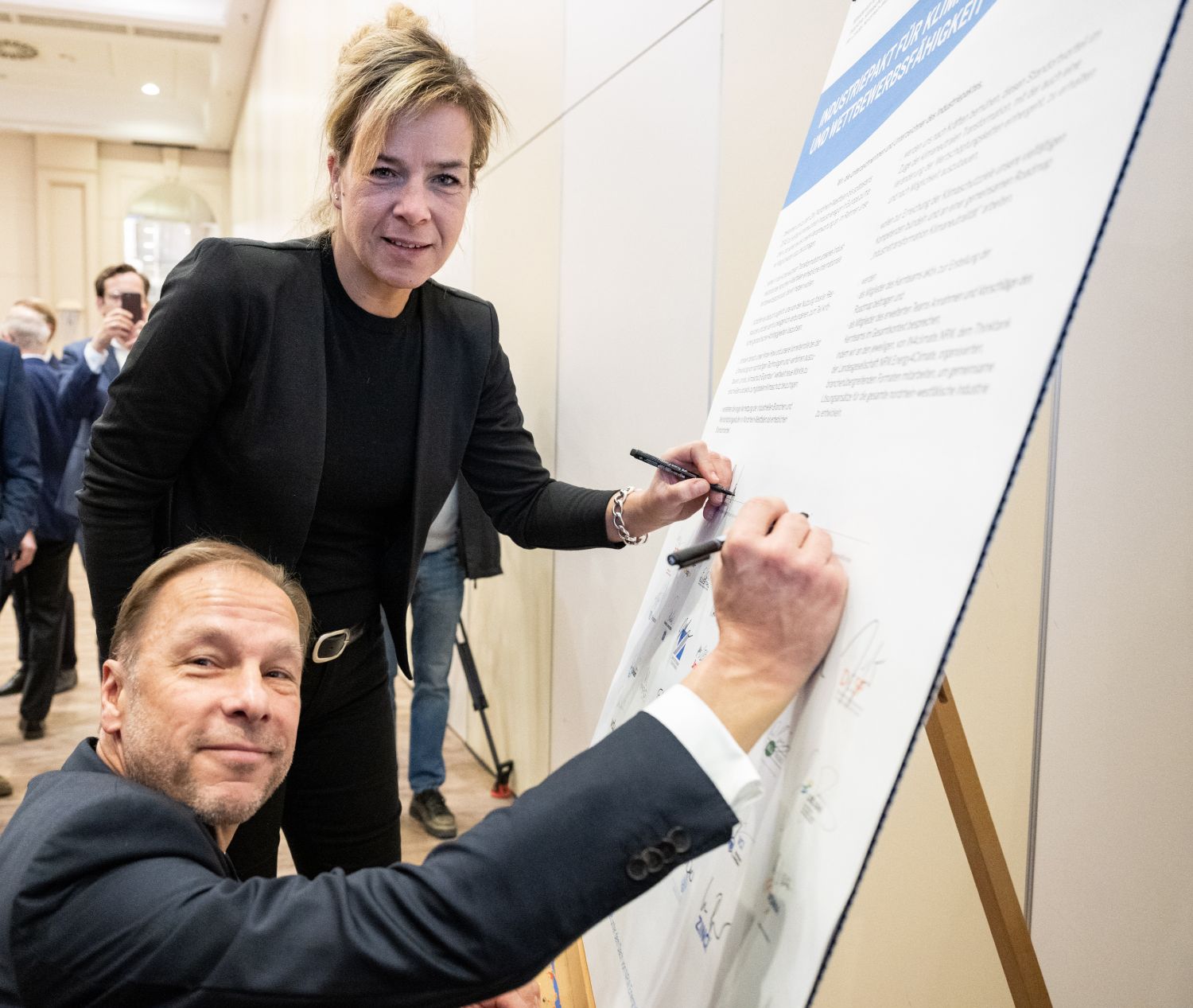 Ministerin Mona Neubauer und Ulf C. Reichardt, der Vorsitzende von NRW.Energy4Climate, unterzeichnen den Industriepakt Nordrhein-Westfalen.